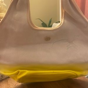 Tory Burch handbag with some black lines on the back and front